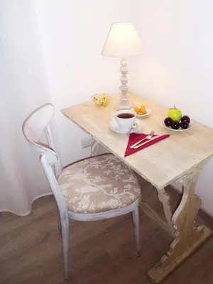 a table with a chair and a table with a lamp at B&B More Than Rome in Rome