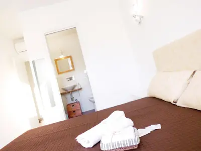 a bedroom with a bed with two white towels on it at B&B More Than Rome in Rome