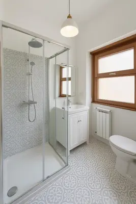 a bathroom with a shower and a toilet and a sink at Sole 34 Apartment in Rome