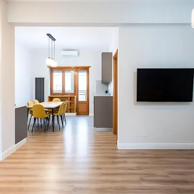 a living room with a table and a tv on a wall at Sole 34 Apartment in Rome