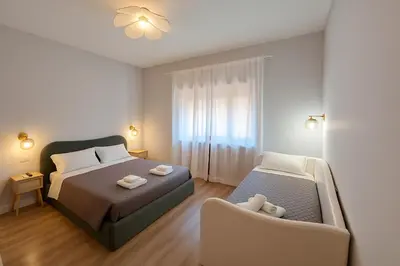 a bedroom with a bed and a chair in it at Sole 34 Apartment in Rome