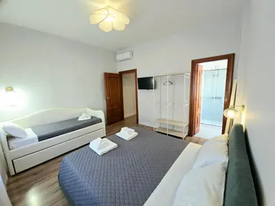 a bedroom with a bed and a couch in it at Sole 34 Apartment in Rome