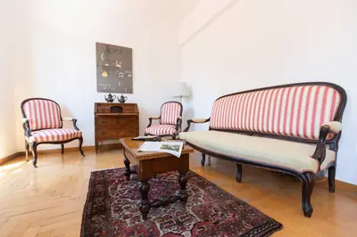 a living room with two chairs and a coffee table at Casa Arezzo - silenzioso trilocale con terrazzino privato - Cale 06 in Rome