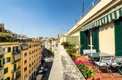 a balcony with a table and chairs on a building at Casa Arezzo - silenzioso trilocale con terrazzino privato - Cale 06 in Rome