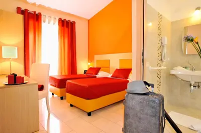 a hotel room with two beds and a bathroom at Hotel Scott House in Rome