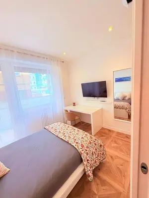a bedroom with a bed and a desk with a television at Vacanze Pamphili in Rome