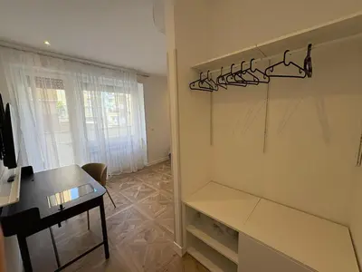 a room with a table and a desk and a room with a closet at Vacanze Pamphili in Rome