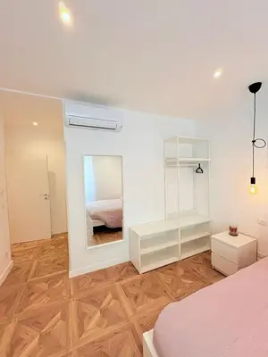 a bedroom with a bed and a mirror at Vacanze Pamphili in Rome