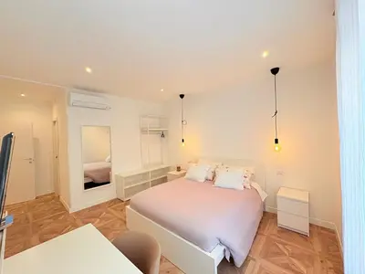 a bedroom with a white bed and a mirror at Vacanze Pamphili in Rome