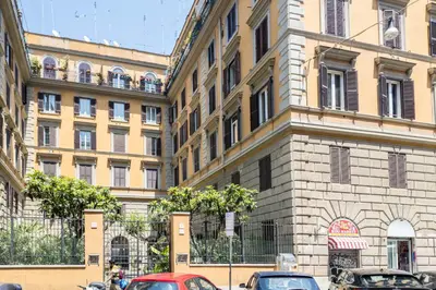 a large building with cars parked in front of it at Maggiore Home in Rome