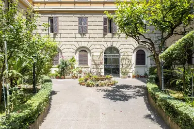 a courtyard of a building with trees and plants at Maggiore Home in Rome