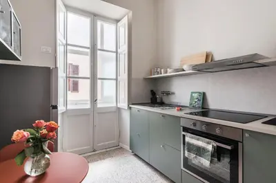 a kitchen with a vase of flowers on a table at Maggiore Home in Rome