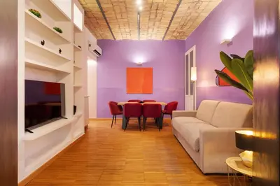a living room with a couch and a table at Quintino Terrace Apartment near Termini Station in Rome
