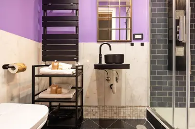 a bathroom with a sink and a shower and a toilet at Quintino Terrace Apartment near Termini Station in Rome