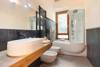 a bathroom with a sink and a tub and a toilet at Quintino Terrace Apartment near Termini Station in Rome