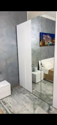 a bathroom with a mirror and a sink and a bed at Cataldo Suites Roma in Rome