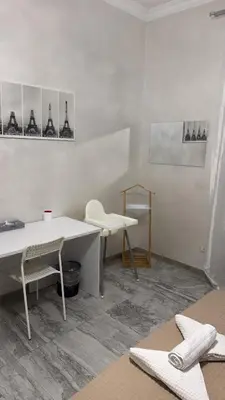 a white room with a desk and a table and chairs at Cataldo Suites Roma in Rome