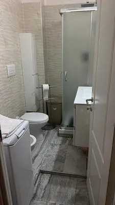 a bathroom with a toilet and a sink and a shower at Cataldo Suites Roma in Rome