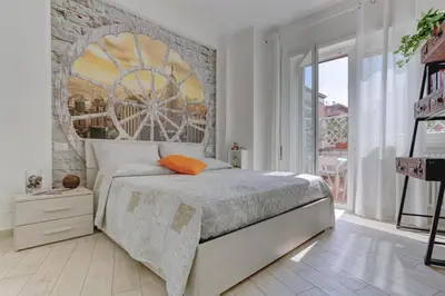 a bedroom with a bed with a large wheel mural on the wall at Delizioso attico con terrazzo in Rome