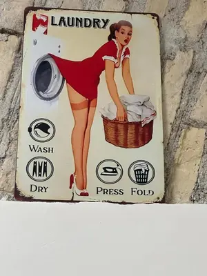 a sign on a wall with a woman in a washing machine at Veronica House in Rome