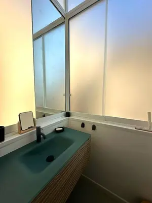 a bathroom with a sink and a large window at Veronica House in Rome