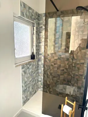 a bathroom with a shower with a glass door at Veronica House in Rome