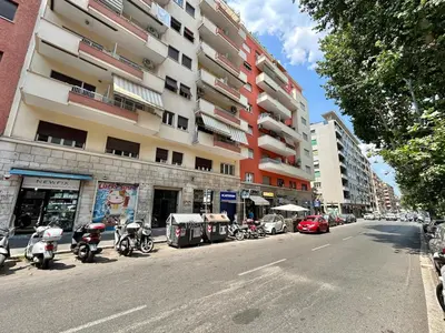 a street with motorcycles parked in front of a tall building at Cipro Vatican Home in Rome