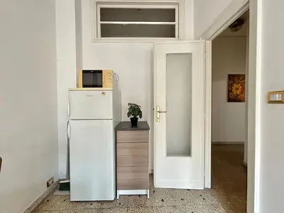 a white refrigerator with a microwave on top of it at Cipro Vatican Home in Rome