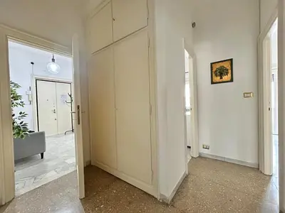 a living room with a white wall and a couch at Cipro Vatican Home in Rome