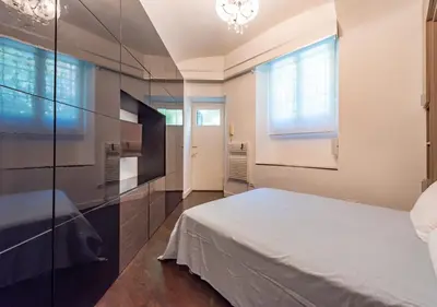 a bedroom with a white bed and a window at Domus Aventino Apartment in Rome