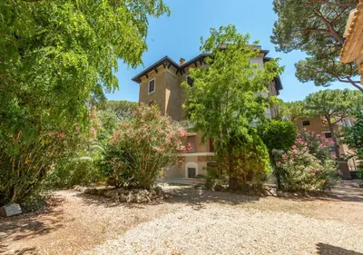 a large house with trees in front of it at Domus Aventino Apartment in Rome