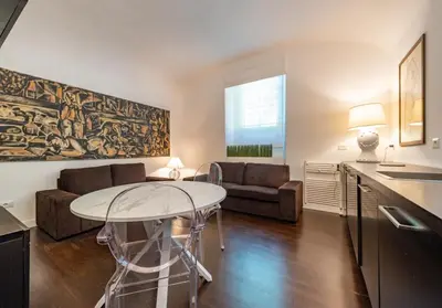 a living room with a table and a couch at Domus Aventino Apartment in Rome