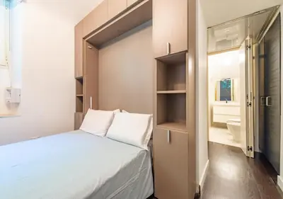 a small bedroom with a bed and a bathroom at Domus Aventino Apartment in Rome