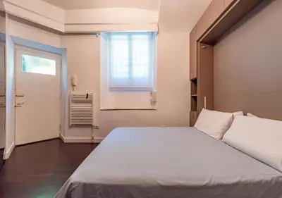 a bedroom with a large bed and a window at Domus Aventino Apartment in Rome