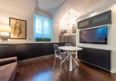 a living room with a table and a tv at Domus Aventino Apartment in Rome