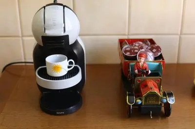 a coffee maker and a toy car next to a coffee mug at Artist's House Colosseum in Rome