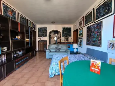 a living room with a bed and a couch at Artist's House Colosseum in Rome