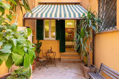 a building with a porch with a table and chairs at Rome Dreamer Suite in Rome