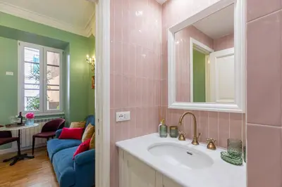 a bathroom with a sink and a mirror at Rome Dreamer Suite in Rome
