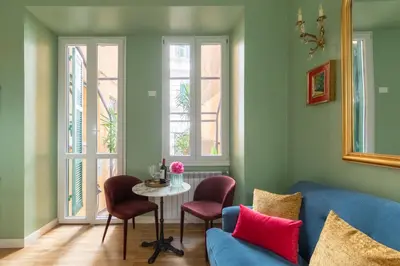 a living room with a blue couch and a table at Rome Dreamer Suite in Rome