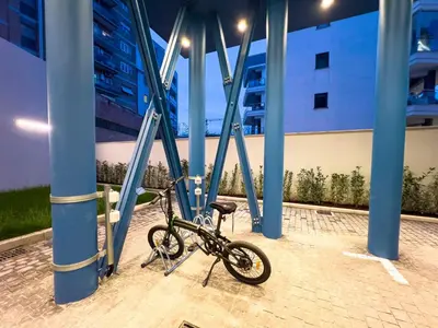 a bike parked in a building with blue columns at Pop House Labicana in Rome