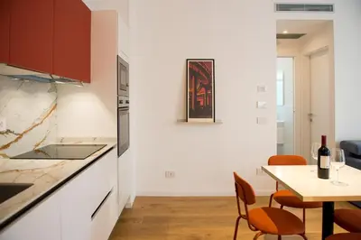 a kitchen and dining room with a table and chairs at Pop House Labicana in Rome