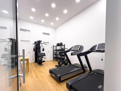 a gym with treadmills and ellipticals in a room at Pop House Labicana in Rome