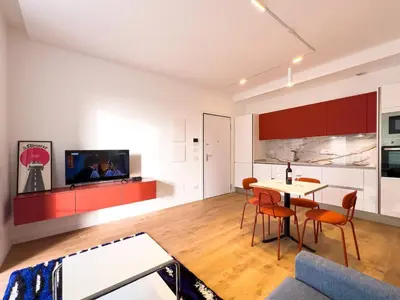 a kitchen and living room with a table and chairs at Pop House Labicana in Rome
