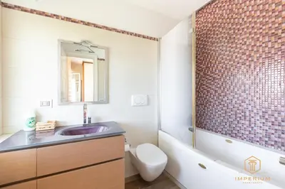 a bathroom with a sink and a tub and a toilet at Imperium Trastevere Flat - 4-6 pax, A-C, Panoramic view, 2 Baths in Rome
