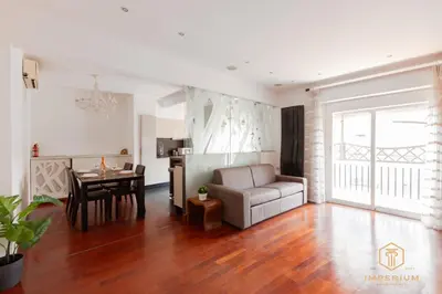 a living room with a couch and a table at Imperium Trastevere Flat - 4-6 pax, A-C, Panoramic view, 2 Baths in Rome