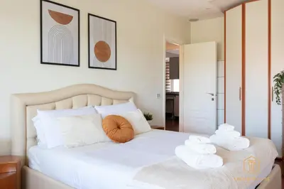 a bedroom with a bed with towels on it at Imperium Trastevere Flat - 4-6 pax, A-C, Panoramic view, 2 Baths in Rome