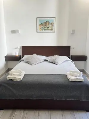 a bedroom with a bed with two towels on it at La Casetta Monteverde in Rome