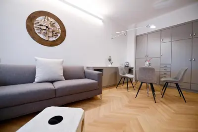 a living room with a couch and a table and a kitchen at Dolce Vita Suite by Rental in Rome in Rome