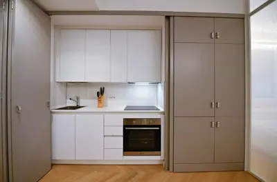 a kitchen with white cabinets and a sink and a stove at Dolce Vita Suite by Rental in Rome in Rome
